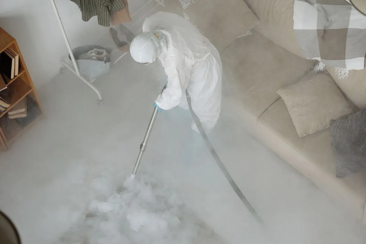 Biohazard cleanup technician in protective equipment, Melissa, TX